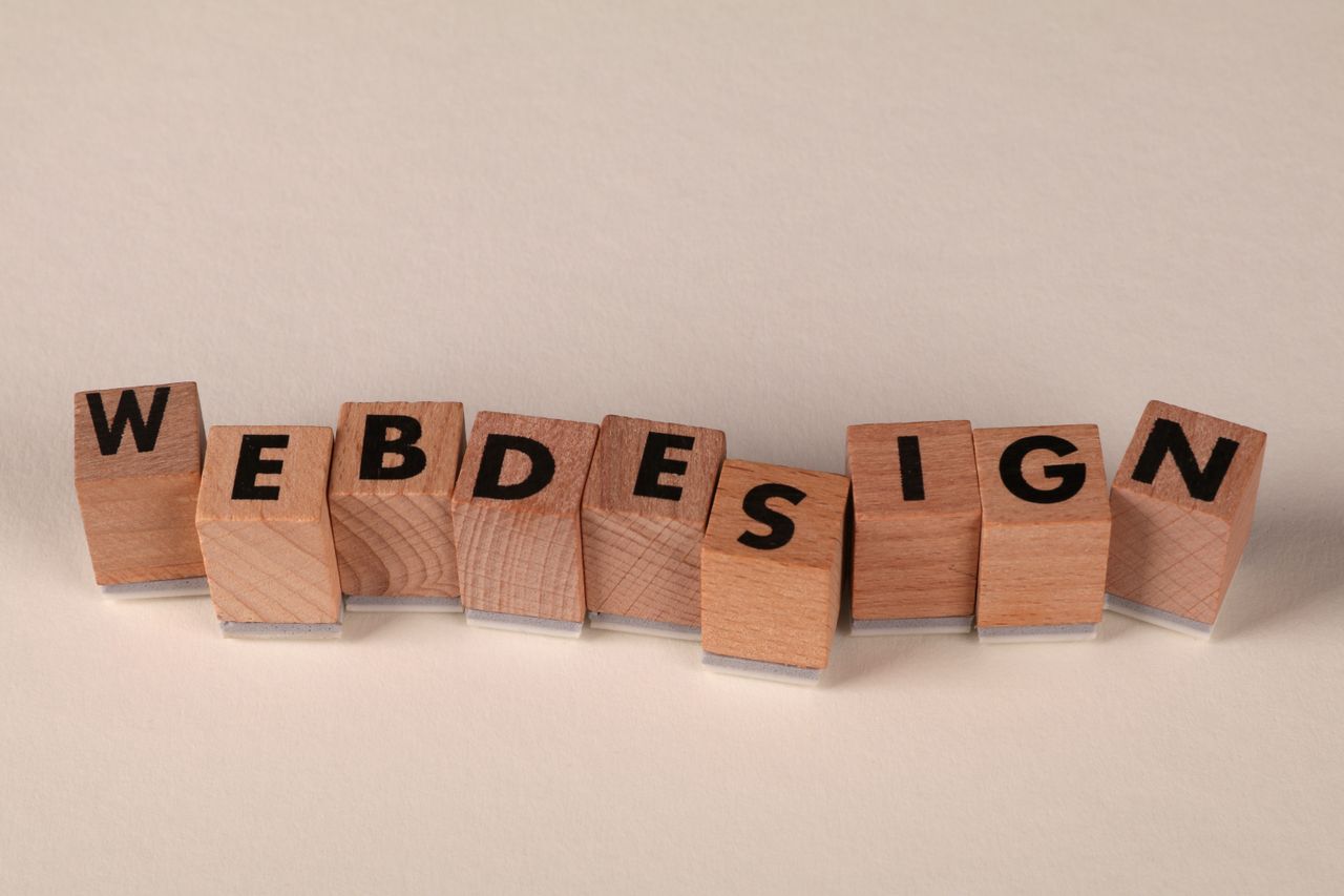 Wooden blocks arranged to spell web design in a creative way highlight the digital design concept.